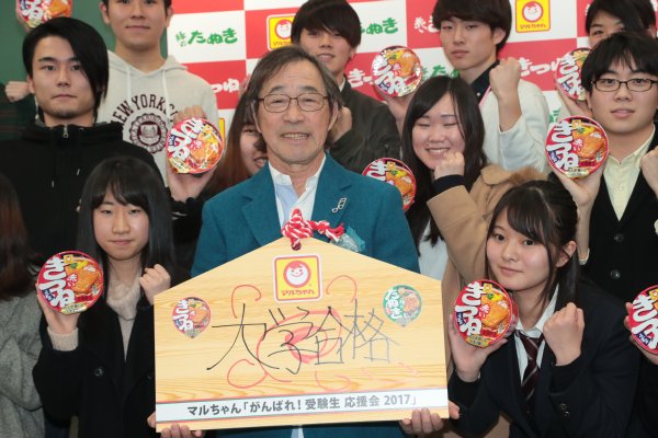 受験生と巨大絵馬とともに記念撮影する武田鉄矢