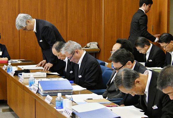 県議会で盗難事件発生を謝罪する県警本部長と幹部たち（写真：共同通信社）