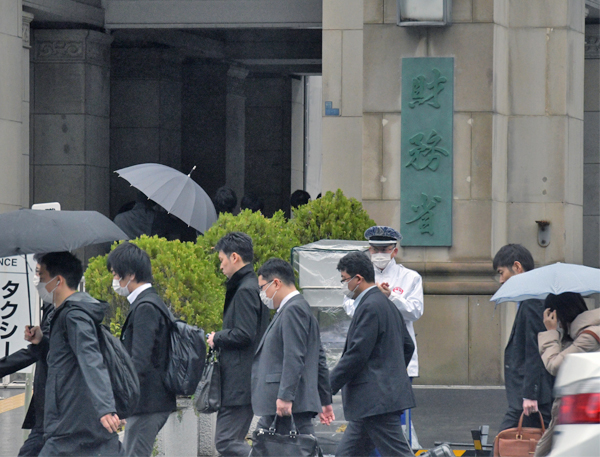 暗い面持ちで財務省に入っていく役人たち
