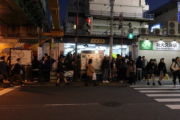 混雑のため車道を歩く人も多い新大久保駅前