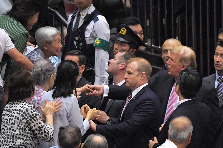 退席時に観客との握手に応じるトランプ大統領（時事通信フォト）