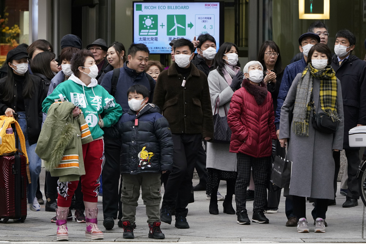 日本各地にマスクをつけた中国人団体客が訪れている（時事通信フォト）