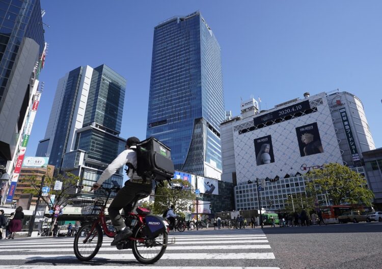 電動アシスト付き自転車で走るフードデリバリーの配達員（時事通信フォト）