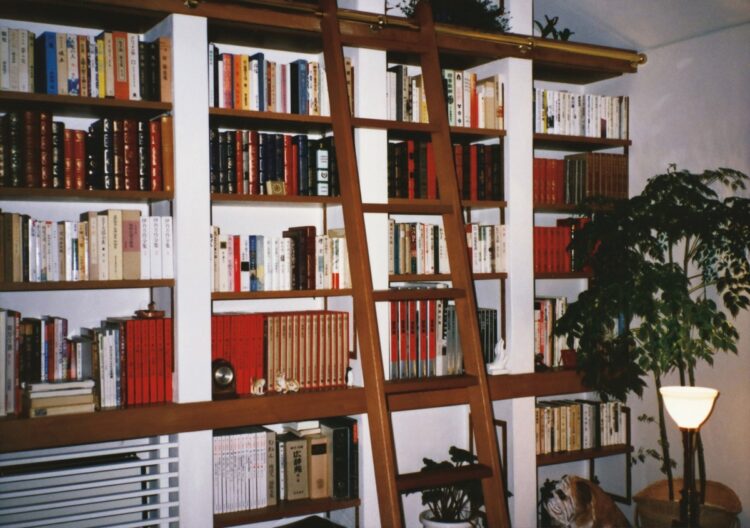 86年に世田谷区に新築した自宅のリビング奥に設けられた書棚には文豪の作品がずらり。子供の頃から読書家だった