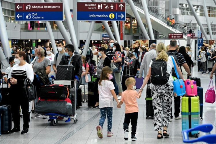 ドイツ人は大の旅行好き。コロナ禍の中でも、長期休暇をとって旅行に出かけようと空港で行列する人々（EPA=時事）