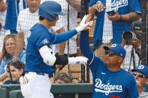 大谷翔平（左）とハイタッチするデーブ・ロバーツ監督（写真／共同通信社）