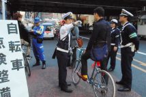 自転車の違反走行の取締りはたびたび実施されてきた。警察官に警告を受ける男性。2011年（イメージ、時事通信フォト）