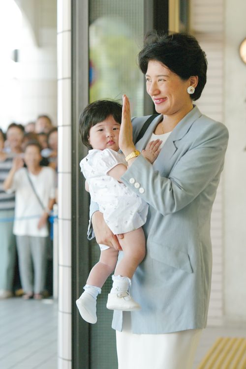 愛子さまを抱え、手を振られる雅子さま（2002年8月、静岡県・下田市。撮影／JMPA）