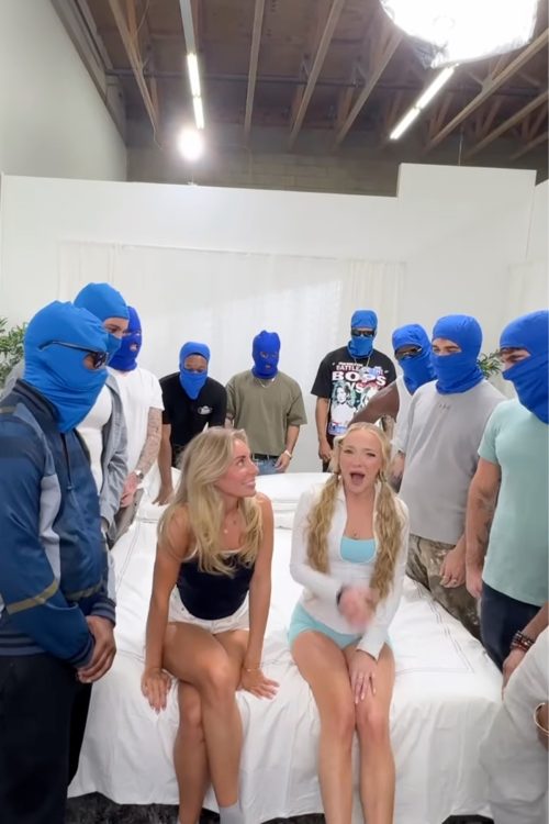 ベッドに腰かけたボニーと仲間の女性を囲む、目出し帽の男たち(インスタグラムより)